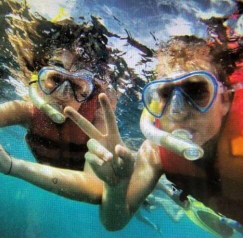 Sabrina Kvist Jensen with her boyfriend Christian Eriksen snorkeling in the ocean.